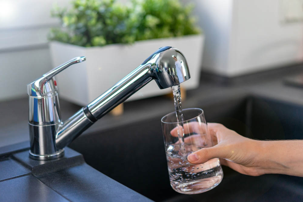 modern kitchen sink with a glass of water