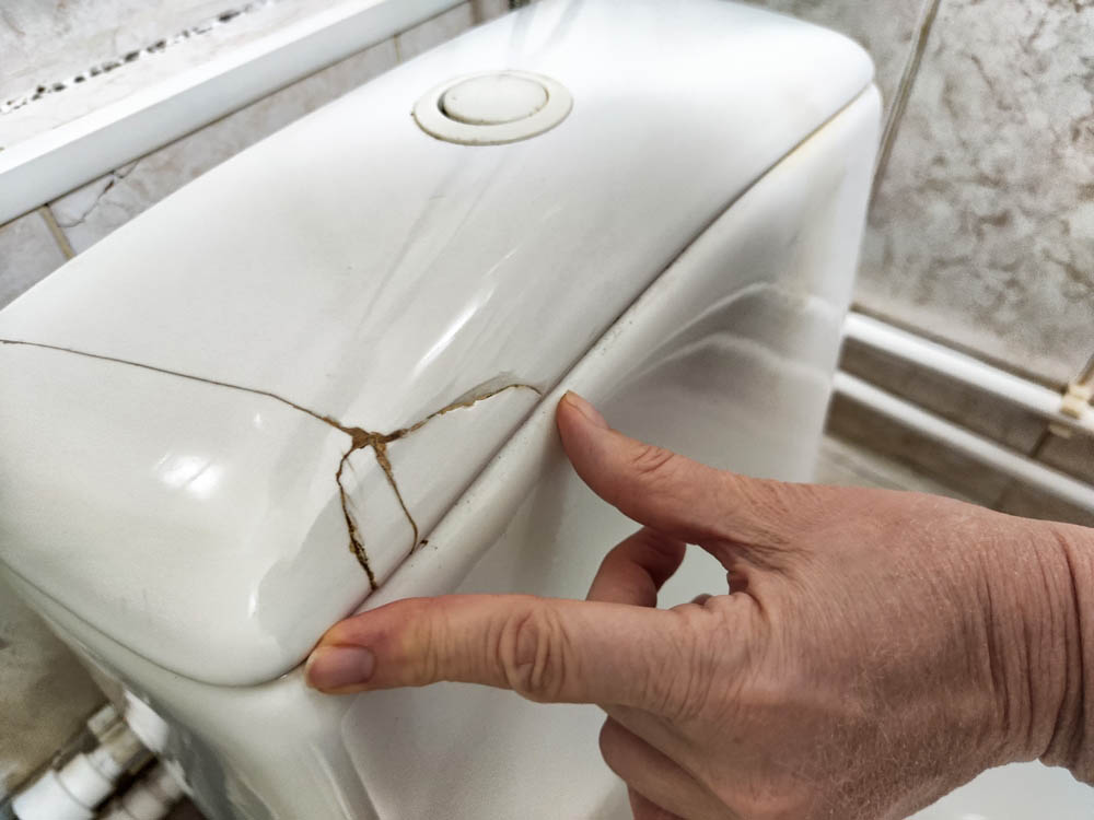 toilet with cracked tank