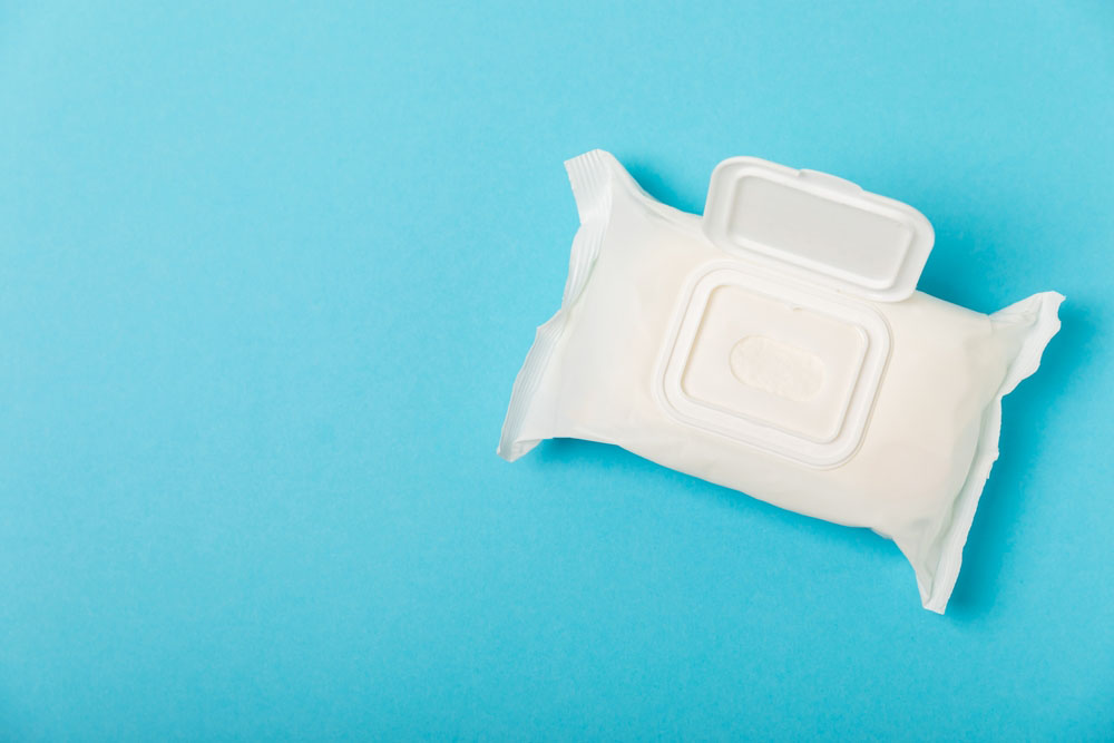 person opening a pack of wet wipes