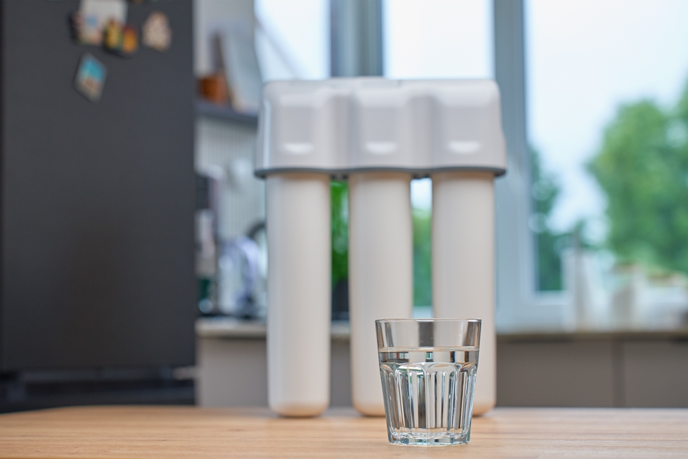 Modern,Water,Filtration,System,With,Three,Cartridges,And,Glass,Of Modern water filtration system with three cartridges and glass of clean water