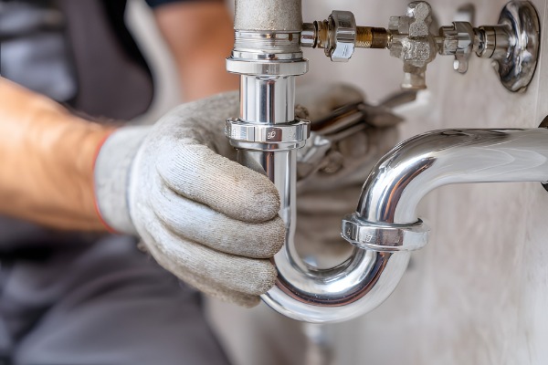 plumber installing sink p-trap