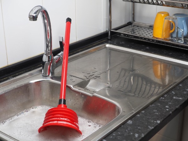 plunging clogged kitchen sink